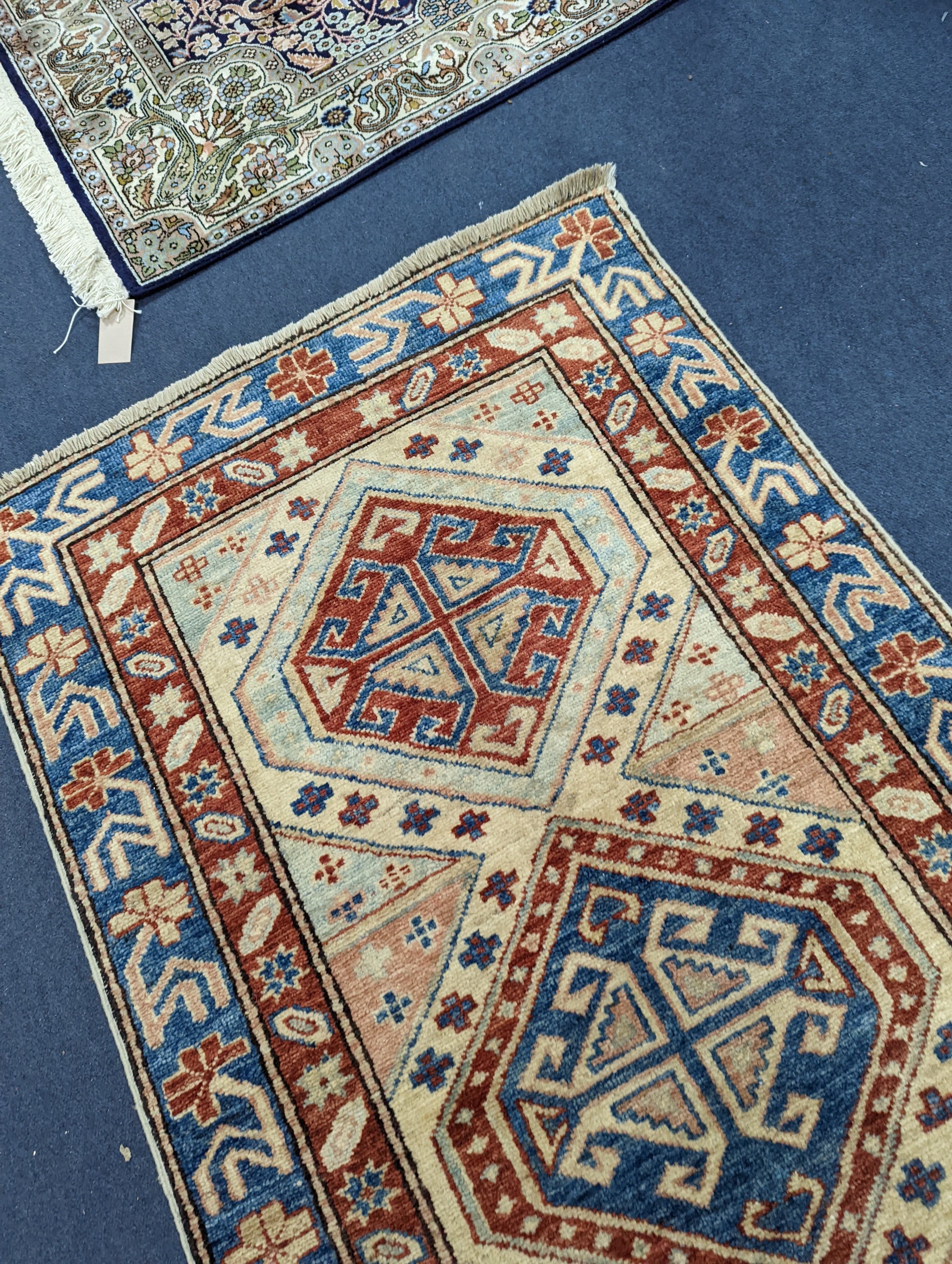 A Caucasian design ivory ground runner, 280 x 70cm